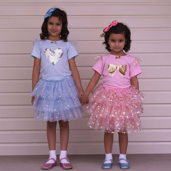 Girls in blue and pink short sleeve tutu & top set decorated with sequins.