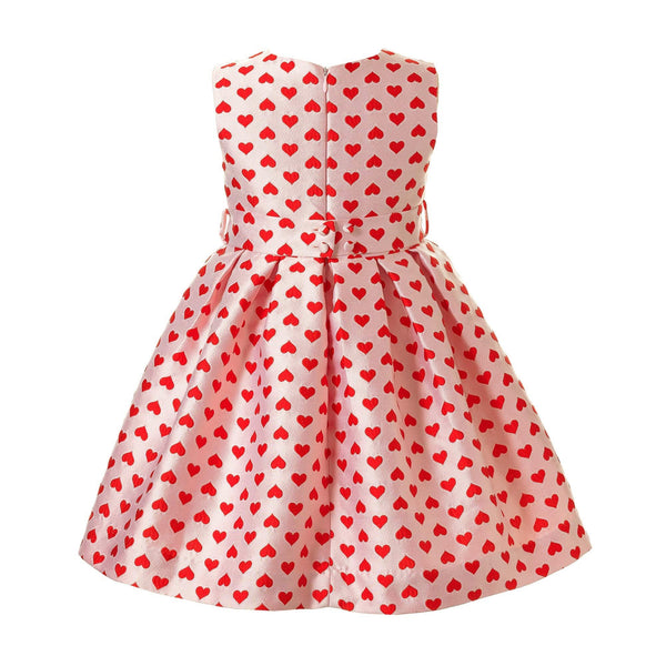 Girls pink damask party dress with bright red hearts and 3D bows at the front waist.