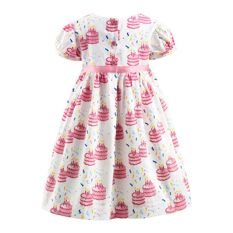 Baby girls party dress with birthday cake print, puff sleeves and pink ribbon and bow at waist.