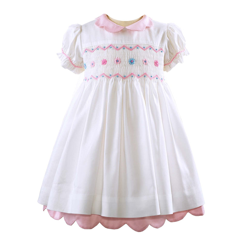 Baby white short-sleeved dress with pink scalloped collar and smocked flower design in pink and blue