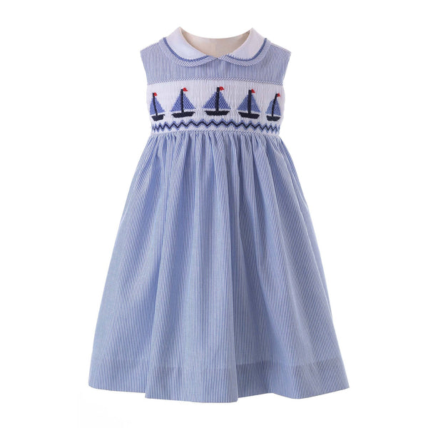 Babies sleeveless blue and ivory stripe dress, with smocked sailboat design and peter pan collar.