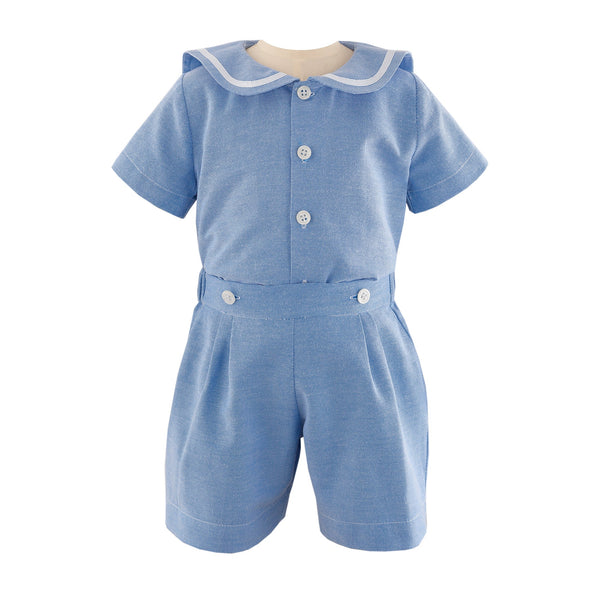 Baby boys blue sailor short sleeved shirt with ivory ribbon on collar and matching turn up shorts.