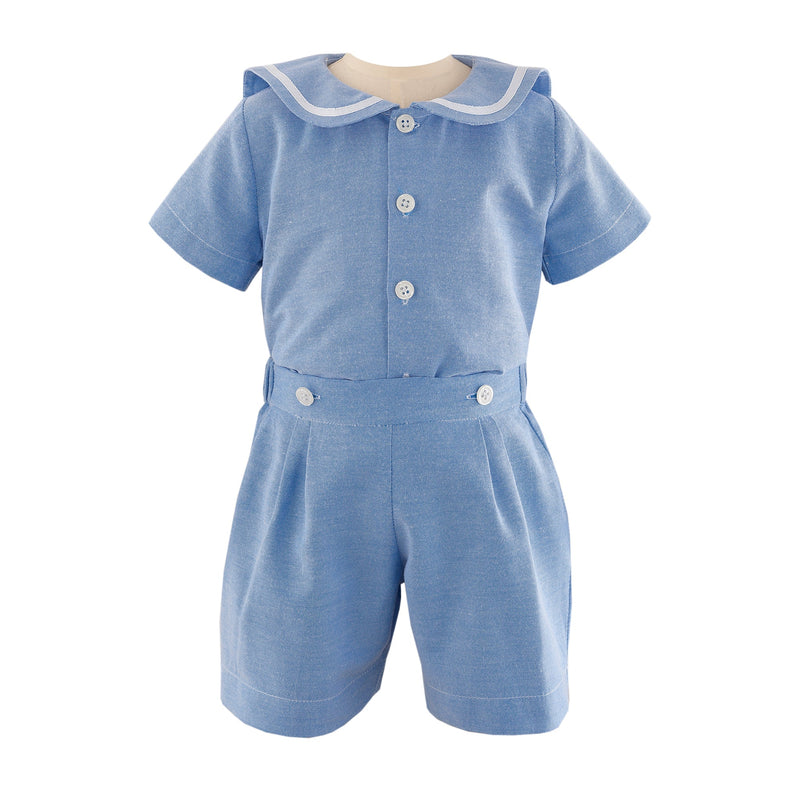 Baby boys blue sailor short sleeved shirt with ivory ribbon on collar and matching turn up shorts.