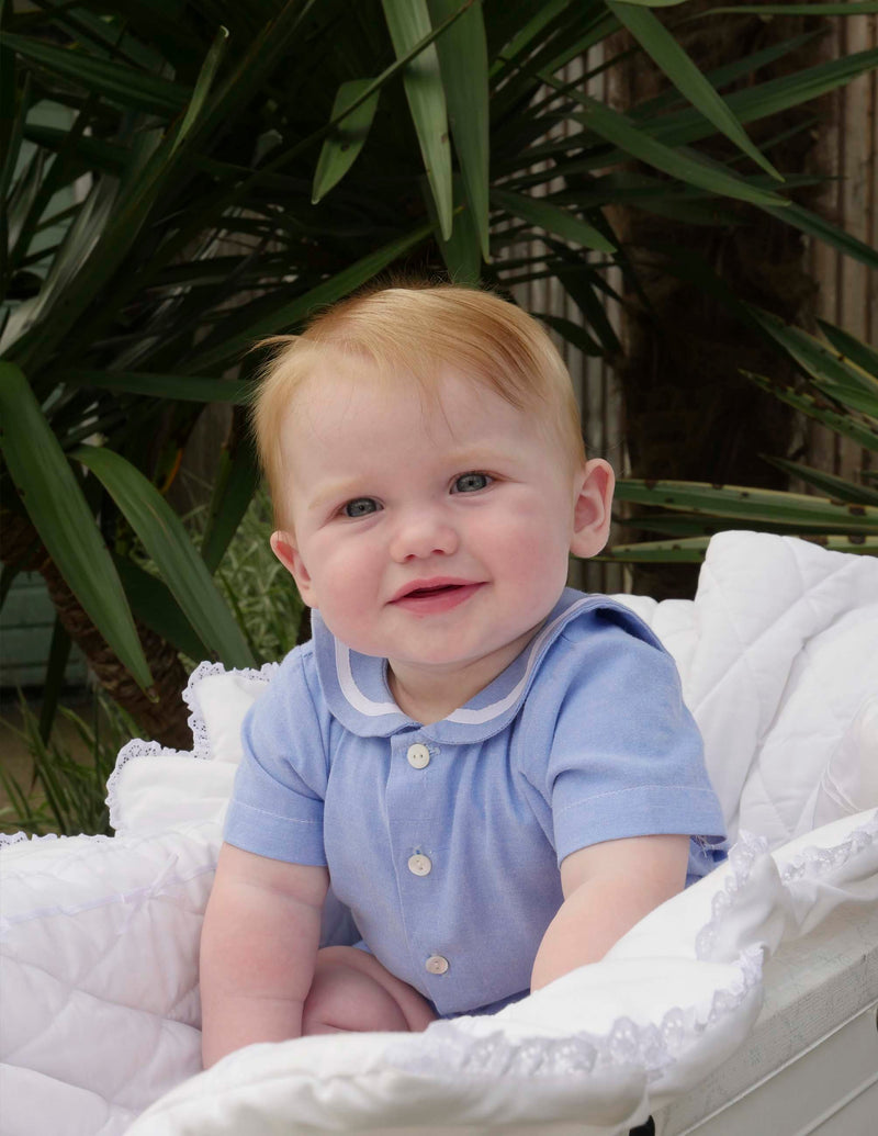 Baby boy wearing blue oxford sailor set.