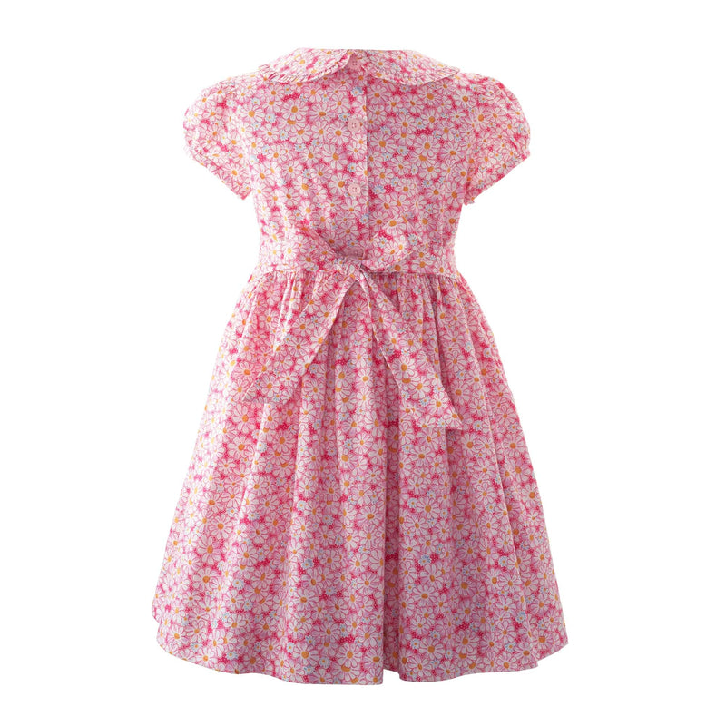 Girls pink floral print dress with frill on the bodice and collar, and puff sleeves.