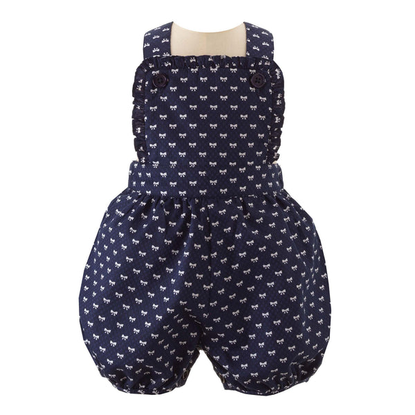 Baby girl navy dungarees, frill trimmed with white mini bow design.