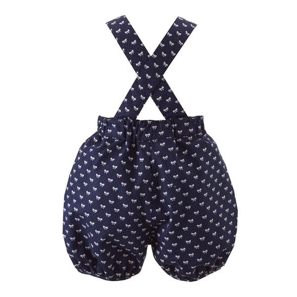 Baby girl navy dungarees, frill trimmed with white mini bow design.