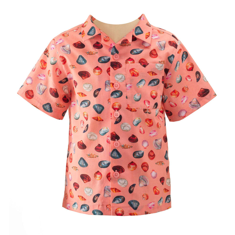 Boys open collar, short sleeved shirt with sandy beach print on peach base.