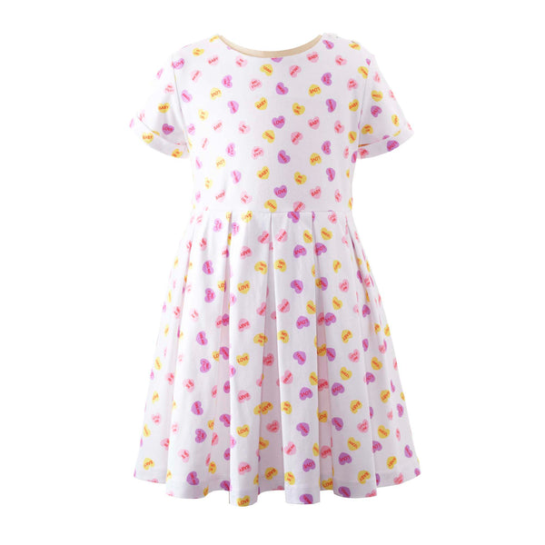 Girls soft cotton jersey dress with playful heart print on ivory base and pleated skirt.