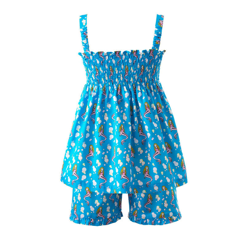 Girls ruched top with bows on straps and matching shorts with mermaid print on deep blue background.