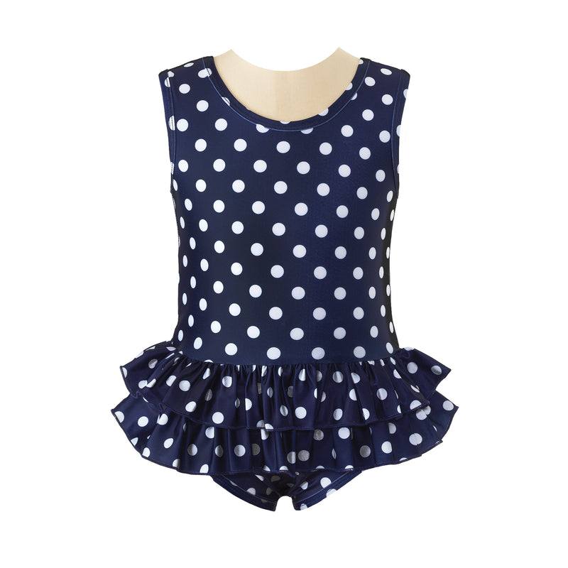 Girls navy pull-on swimsuit with ivory polka dot print, matching binding and double ruffle at waist