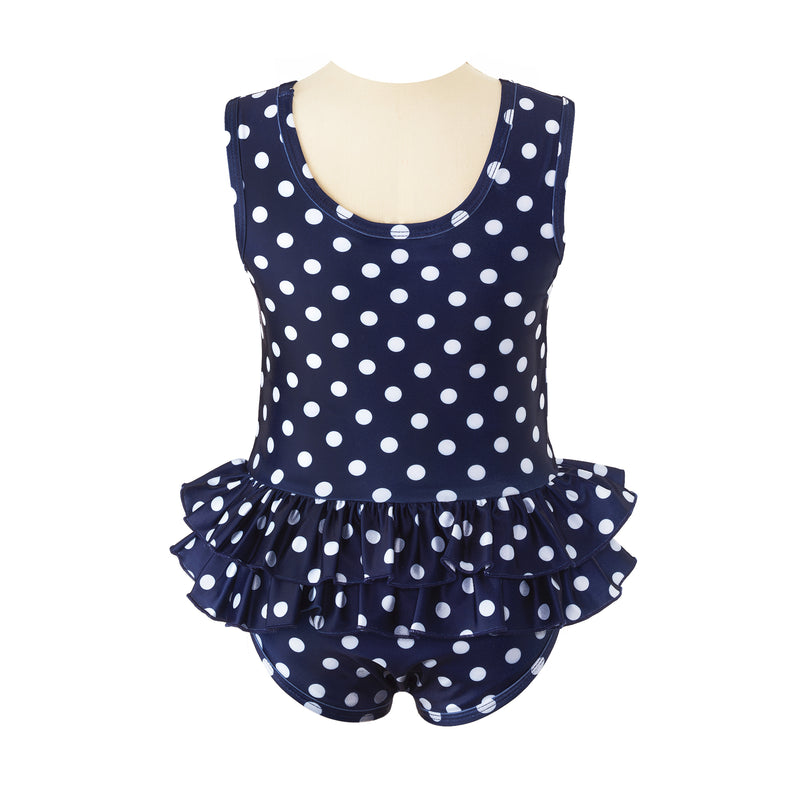 Girls navy pull-on swimsuit with ivory polka dot print, matching binding and double ruffle at waist