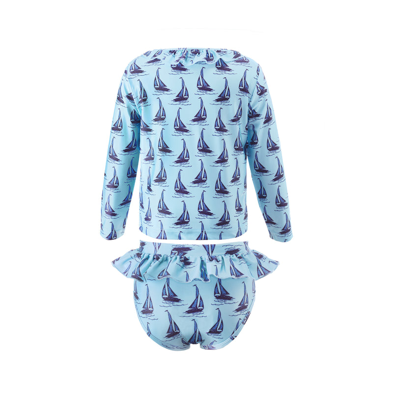 Girl two piece rash guard with long sleeves and frill bottom, with sailboat print on blue background