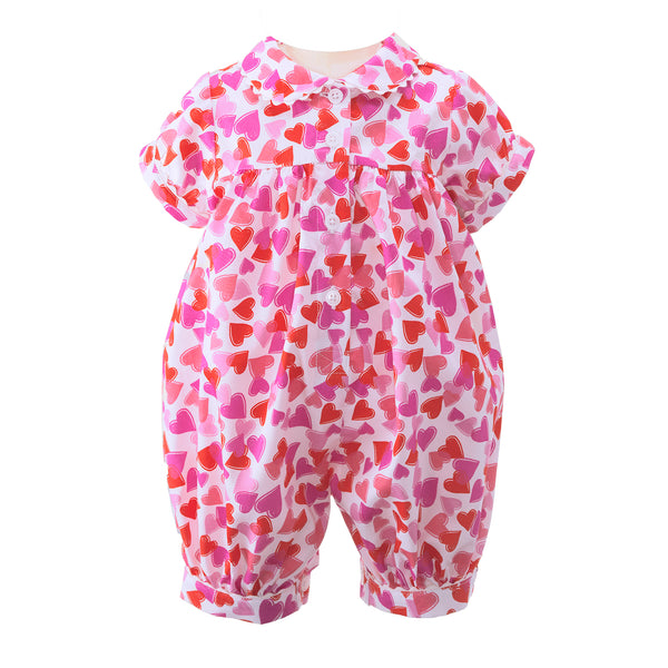 Baby girl babysuit with pink and red heart print on ivory base and peter pan collar.