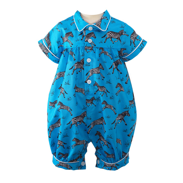 Baby boys cotton babysuit with galloping zebra print on deep blue background.