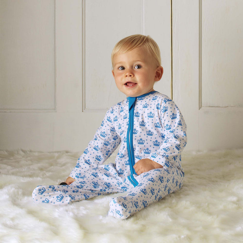 Baby boy wearing soft cotton babygro with blue polka dot crown print, with zip fastening.