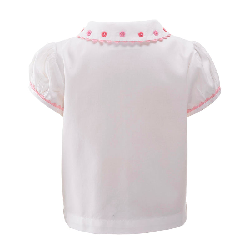 Baby white blouse with pink daisy embroidered peter pan collar, trimmed with frills and pink piping.