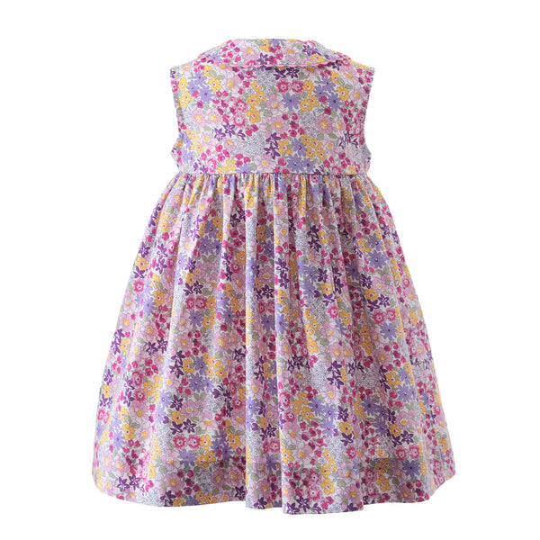Babies sleeveless button-front dress in summer floral print, ricrac trims and peter pan collar.