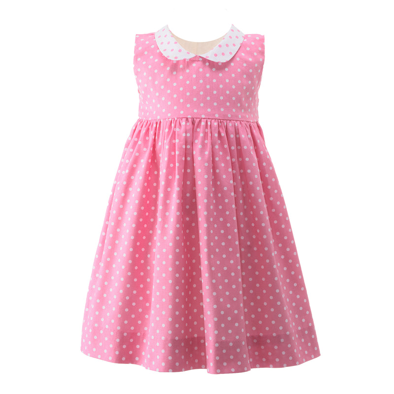 Babies pink sleeveless dress with white polka dot print, contrasting peter pan collar and sash tie.
