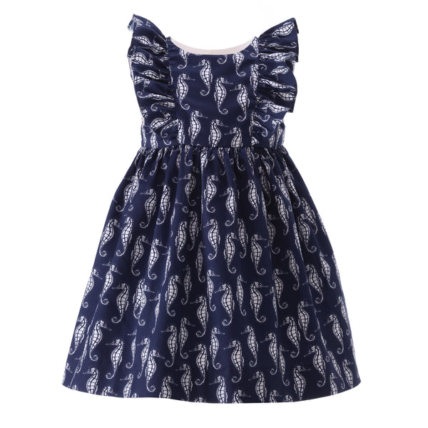 Babies sleeveless dress with seahorse print on navy base and gathered frills at the shoulders.