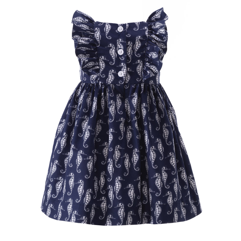 Babies sleeveless dress with seahorse print on navy base and gathered frills at the shoulders.