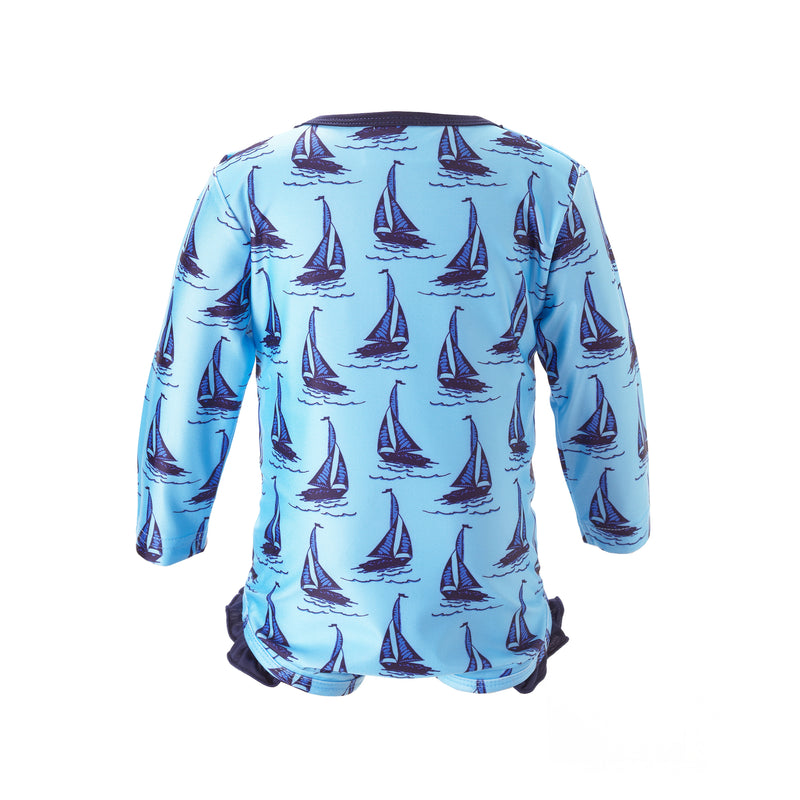 Baby blue one piece rash guard with sailboat print, long sleeves and frill at the leg.