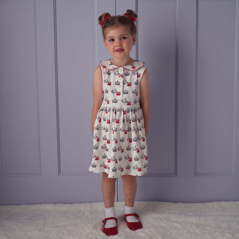 Girl in royal tea party jersey dress and matching red haibows and slippers.
