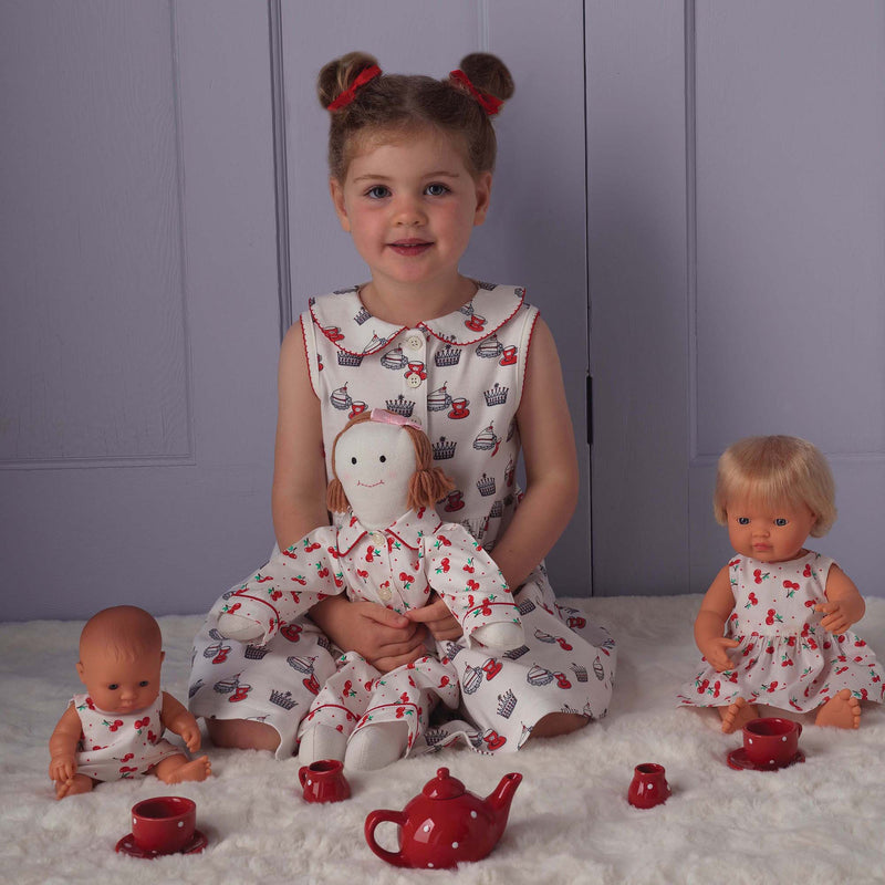Girl in royal tea party jersey dress and matching red haibows and slippers.