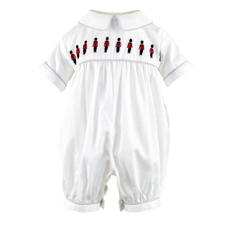 Ivory babysuit with soldier embroidered motif on chest and grey piping at collar and cuffs.