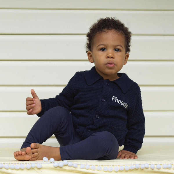 Baby boy wearing navy moss stitch cardigan, styled with navy knitted trousers.