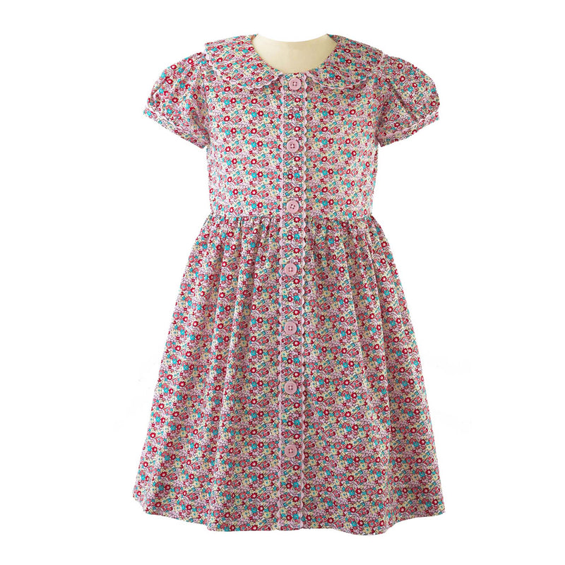 Girls ditsy floral button-front dress with puff sleeves, coordinating ricrac trims and buttons.