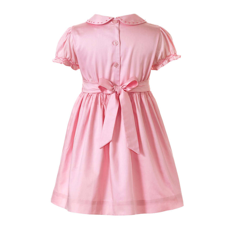 Girls pink dress with smocked bodice, embroidered with bows, peter pan collar and gathered skirt.