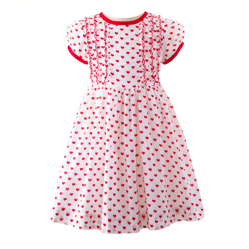 Girls ivory dress with red heart print and frill detail at the bodice, red trim and sash at the back