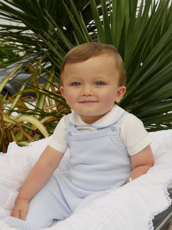 Baby boy wearing blue piping peter pan collar body styled with blue moss stitch strap romper.