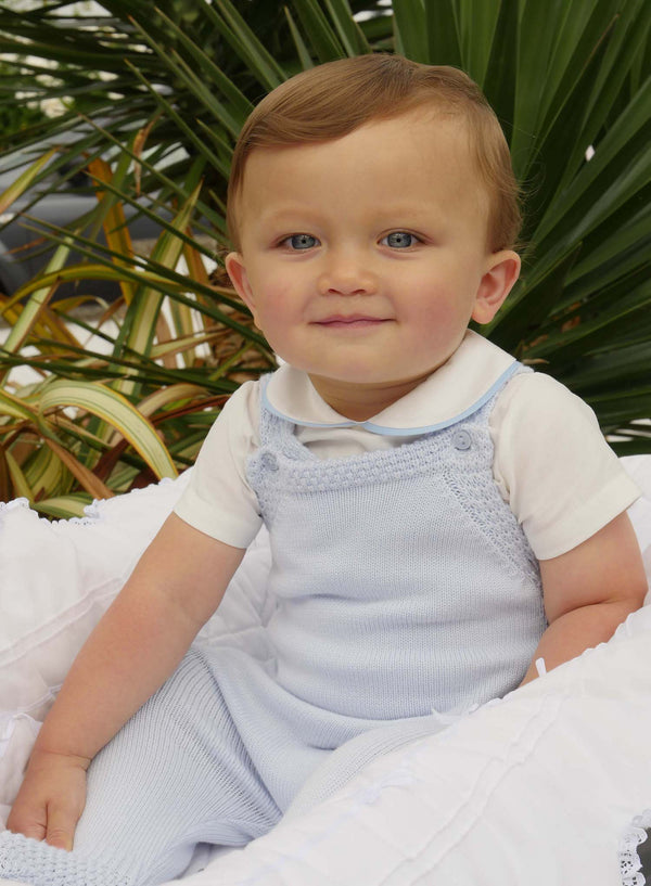 Baby boy wearing blue moss stitch strap romper styled with blue piping collar shirt.