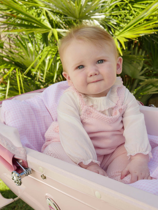 Baby girl wearing pink moss stitch strap romper styled with pink frill trim collar body.