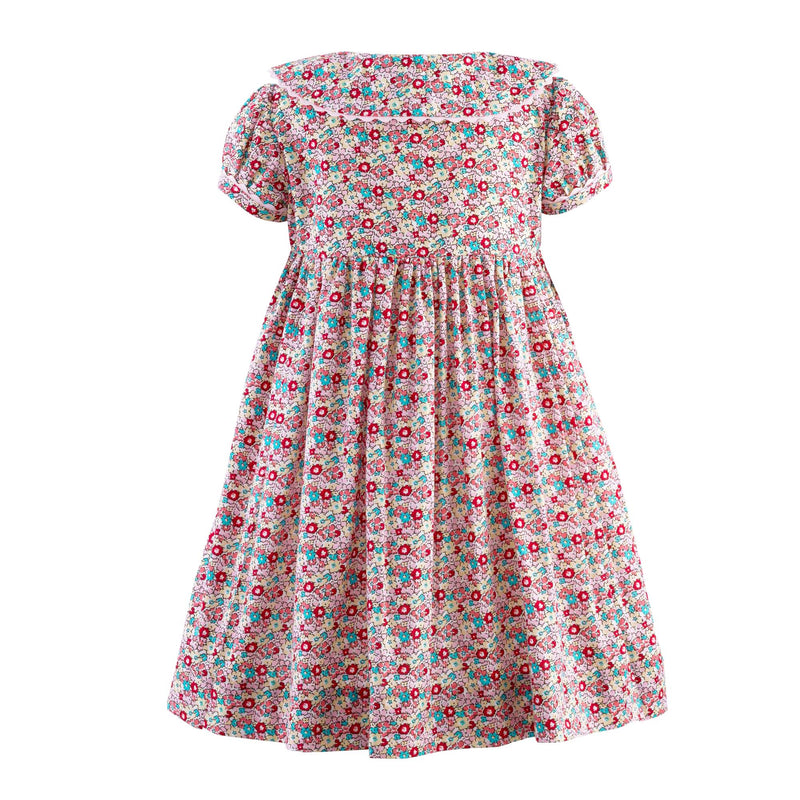 Babies ditsy floral button-front dress with puff sleeves, coordinating ricrac trims and buttons.
