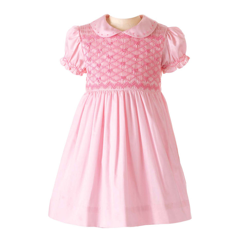 Baby girls pink dress with smocked bodice, embroidered bows, peter pan collar and gathered skirt.