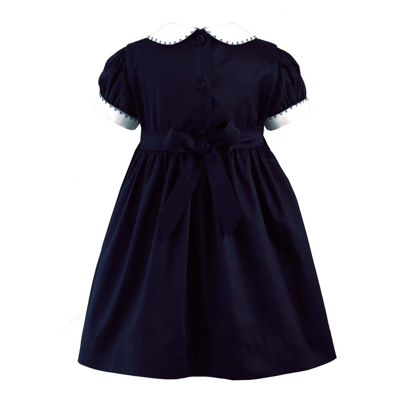 Babies navy smocked dress with ivory peter pan collar and short puff sleeves.