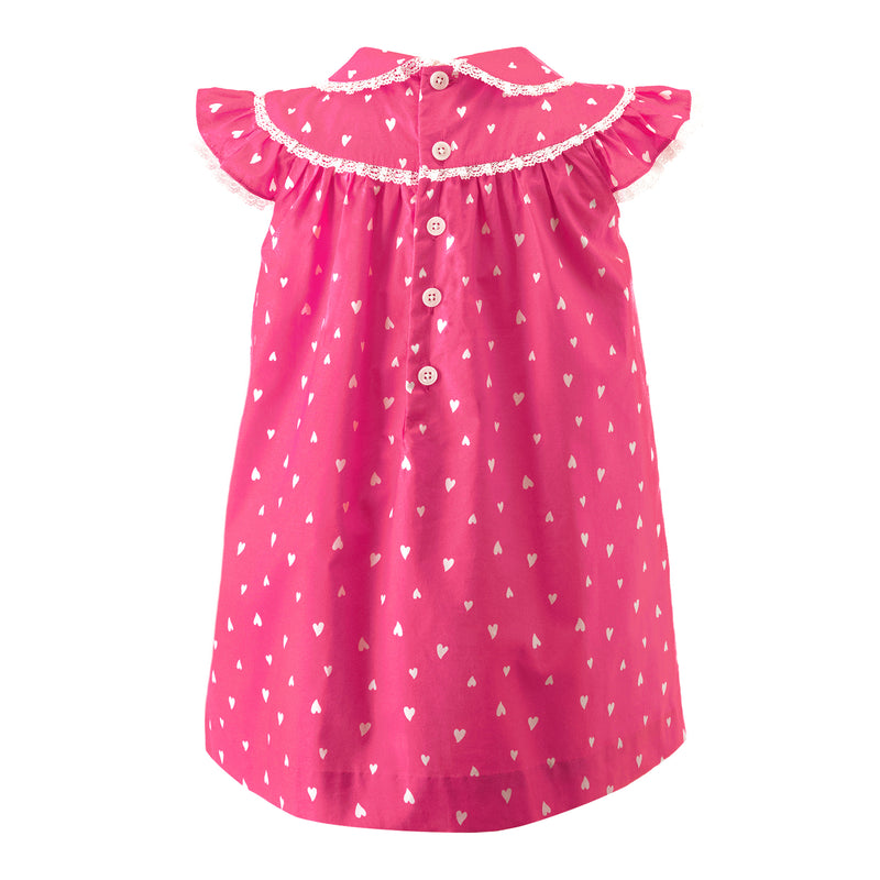 Girls pink gathered dress with white hearts print, peter pan collar and frills at neck and shoulders